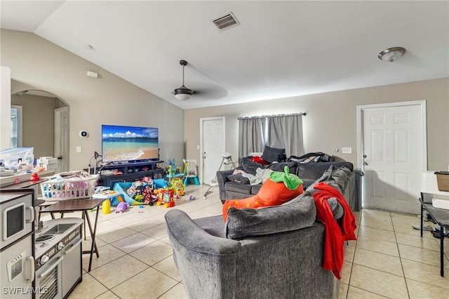 3309 19th St W, Lehigh Acres, FL 33971 - living room featuring light tile patterned flooring, arched walkways, lofted ceiling, and ceiling fan