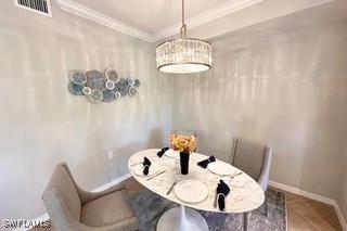 9834 Giaveno Cir Unit 1716, Naples, FL 34113 - dining area with crown molding and baseboards