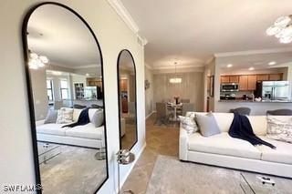 9834 Giaveno Cir Unit 1716, Naples, FL 34113 - living area with ornamental molding and arched walkways