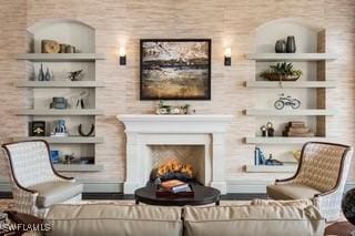 9834 Giaveno Cir Unit 1716, Naples, FL 34113 - sitting room with a warm lit fireplace