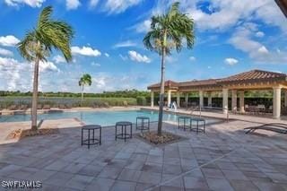 9834 Giaveno Cir Unit 1716, Naples, FL 34113 - community pool featuring a patio