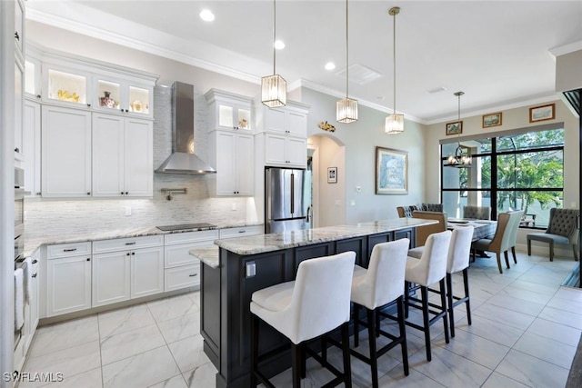605 SW 39th Ave, Cape Coral, FL 33991 - kitchen featuring freestanding refrigerator, wall chimney range hood, arched walkways, a center island, and ornamental molding
