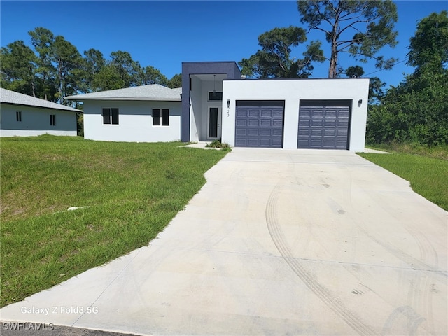 521 Frank Jewett Ave S, Lehigh Acres, FL 33974 - contemporary house with driveway, stucco siding, an attached garage, and a front lawn