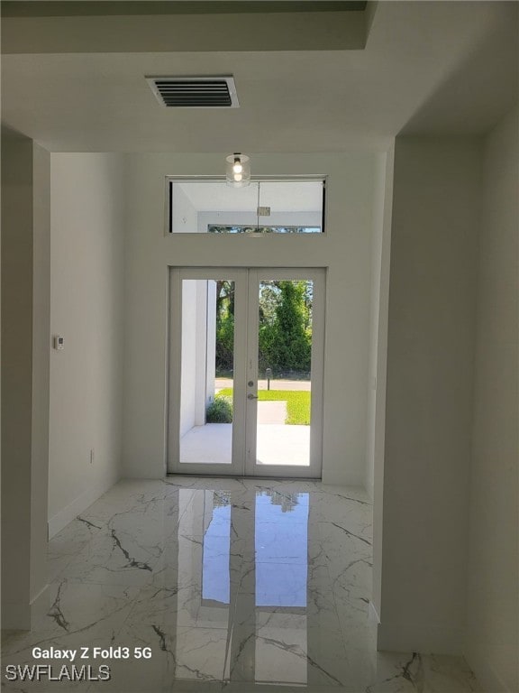 521 Frank Jewett Ave S, Lehigh Acres, FL 33974 - doorway with marble tiled flooring and french doors