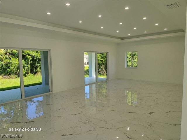 521 Frank Jewett Ave S, Lehigh Acres, FL 33974 - empty room featuring marble tiled flooring, recessed lighting, and a raised ceiling