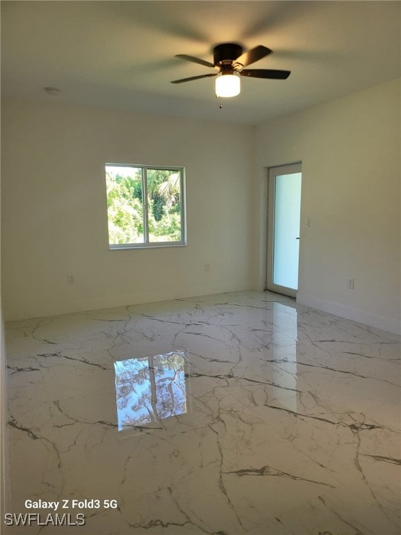 521 Frank Jewett Ave S, Lehigh Acres, FL 33974 - unfurnished room with ceiling fan and marble tiled floors
