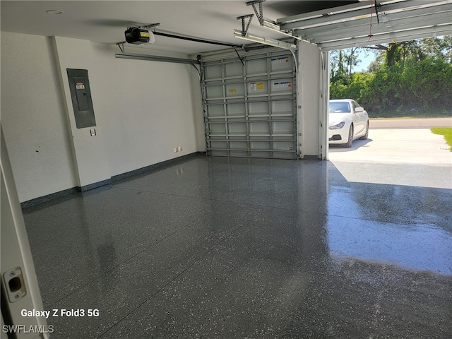 521 Frank Jewett Ave S, Lehigh Acres, FL 33974 - garage with electric panel, a garage door opener, and baseboards