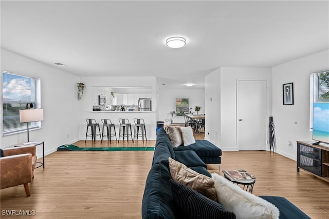 3303 6th St SW, Lehigh Acres, FL 33976 - living area featuring wood finished floors and baseboards