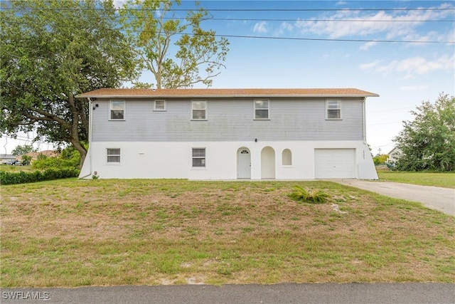3303 6th St SW, Lehigh Acres, FL 33976 - view of front of property featuring concrete driveway, a garage, a front yard, and stucco siding