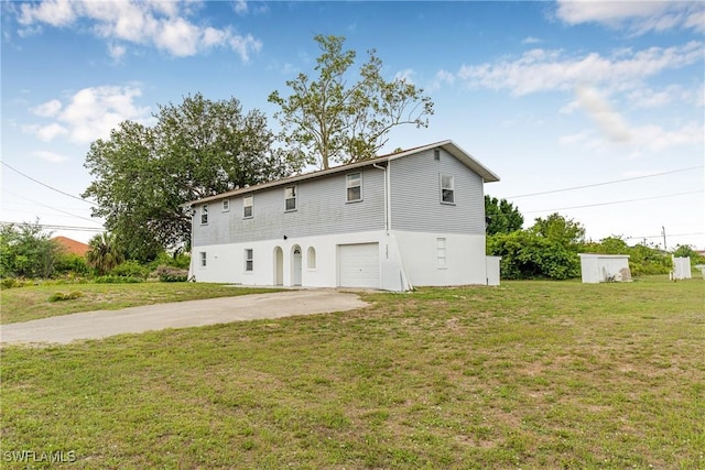 3303 6th St SW, Lehigh Acres, FL 33976 - back of property with driveway, a garage, and a yard