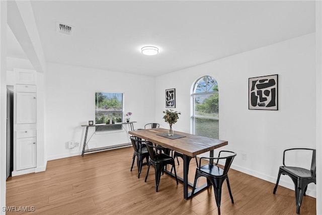 3303 6th St SW, Lehigh Acres, FL 33976 - dining area featuring light wood-style flooring and baseboards