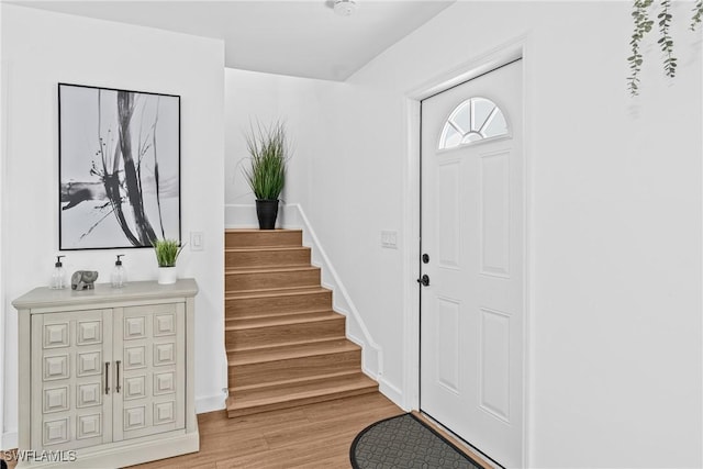 3303 6th St SW, Lehigh Acres, FL 33976 - entryway featuring light wood finished floors, stairway, and baseboards
