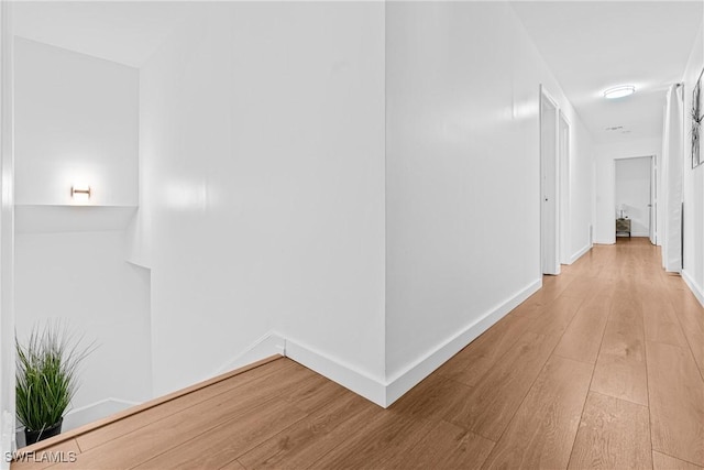 3303 6th St SW, Lehigh Acres, FL 33976 - corridor with wood finished floors and baseboards