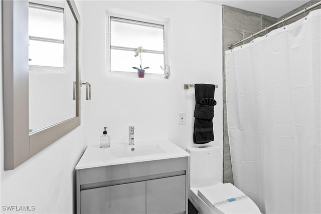 3303 6th St SW, Lehigh Acres, FL 33976 - full bath featuring toilet, vanity, plenty of natural light, and a shower with curtain
