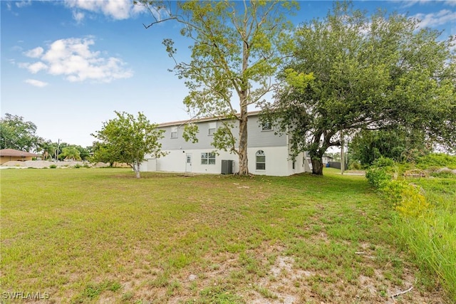 3303 6th St SW, Lehigh Acres, FL 33976 - view of green lawn with central air condition unit
