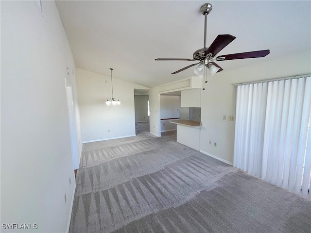 1706 Forest Lakes Blvd, Naples, FL 34105 - unfurnished living room with vaulted ceiling, light colored carpet, a ceiling fan, baseboards, and a chandelier
