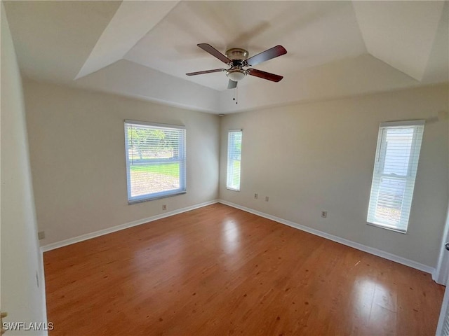 1706 Forest Lakes Blvd, Naples, FL 34105 - empty room with a tray ceiling, light wood-style flooring, a ceiling fan, baseboards, and vaulted ceiling