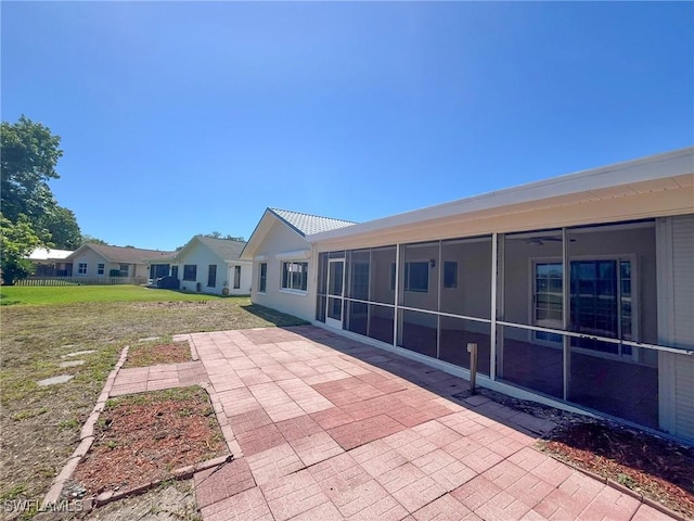 1706 Forest Lakes Blvd, Naples, FL 34105 - rear view of house with a patio, a sunroom, and a yard