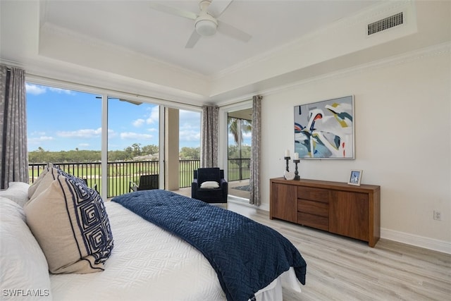 560 El Camino Real Unit 1304, Naples, FL 34119 - bedroom featuring a tray ceiling, access to exterior, light wood finished floors, baseboards, and crown molding