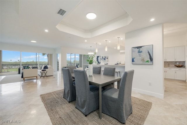 560 El Camino Real Unit 1304, Naples, FL 34119 - dining area featuring recessed lighting, a tray ceiling, and ornamental molding