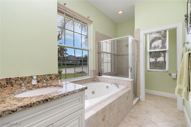 16121 Sand Ridge Ct, Fort Myers, FL 33908 - full bathroom with a stall shower, a tub with jets, vanity, tile patterned flooring, and baseboards
