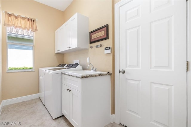 16121 Sand Ridge Ct, Fort Myers, FL 33908 - laundry area with independent washer and dryer, baseboards, cabinet space, and light tile patterned floors