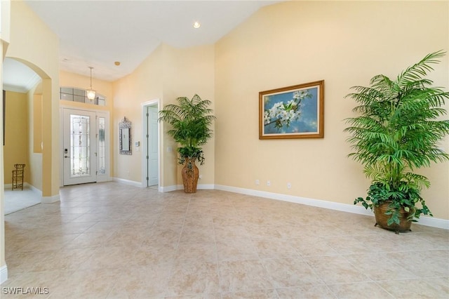 16121 Sand Ridge Ct, Fort Myers, FL 33908 - entryway with arched walkways, light tile patterned floors, baseboards, a high ceiling, and recessed lighting