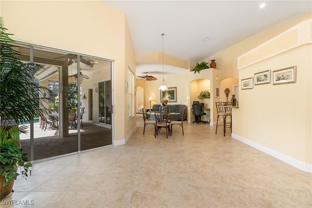 16121 Sand Ridge Ct, Fort Myers, FL 33908 - dining space with arched walkways, baseboards, light tile patterned flooring, and a towering ceiling