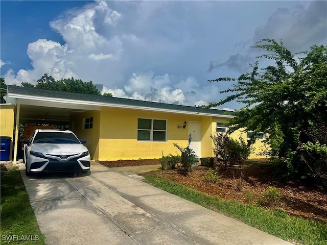 118 Alcala Ave, Lehigh Acres, FL 33936 - ranch-style home featuring driveway and an attached carport