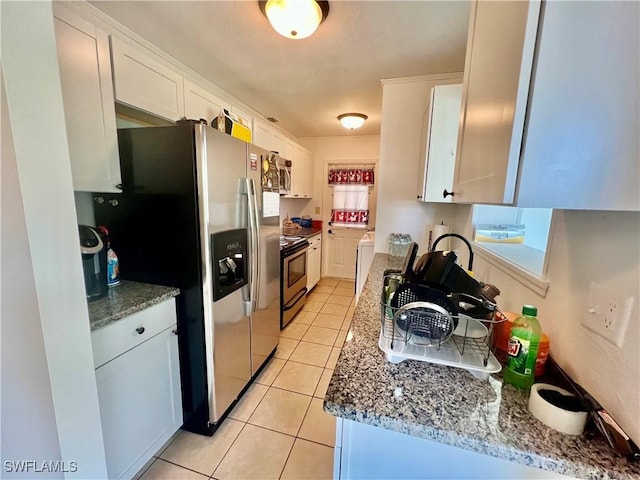118 Alcala Ave, Lehigh Acres, FL 33936 - kitchen with stainless steel appliances, light tile patterned floors, white cabinetry, and stone countertops