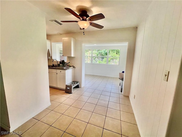 118 Alcala Ave, Lehigh Acres, FL 33936 - kitchen featuring white cabinetry, dark countertops, a sink, a ceiling fan, and light tile patterned floors