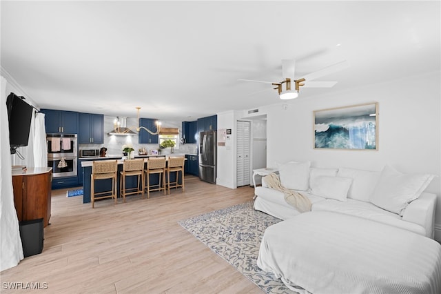 1549 Sandpiper St Unit 39, Naples, FL 34102 - living room with light wood-style floors, a ceiling fan, and a chandelier