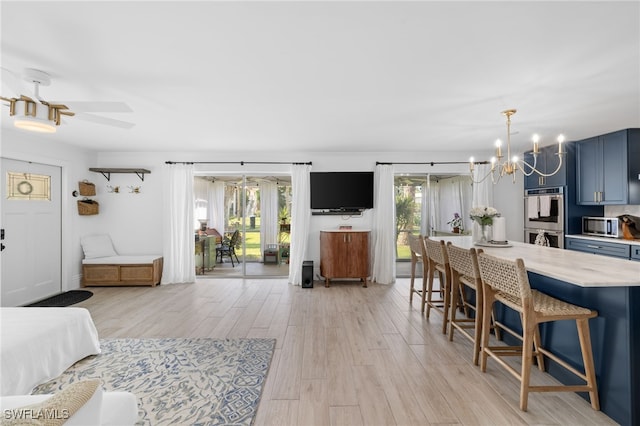 1549 Sandpiper St Unit 39, Naples, FL 34102 - bedroom with a chandelier, access to exterior, and light wood-type flooring
