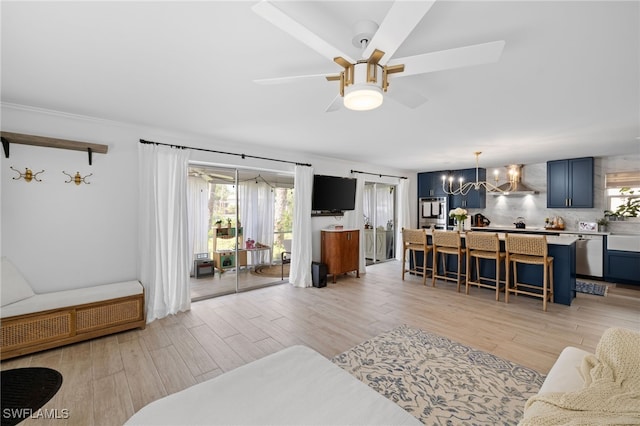 1549 Sandpiper St Unit 39, Naples, FL 34102 - living room featuring light wood-style floors, a chandelier, and ceiling fan