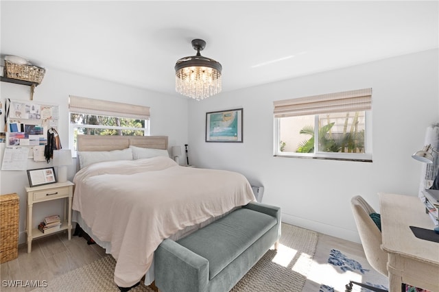 1549 Sandpiper St Unit 39, Naples, FL 34102 - bedroom featuring a chandelier and light wood finished floors