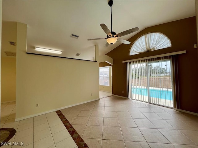 spare room featuring light tile patterned floors, a ceiling fan, baseboards, and high vaulted ceiling
