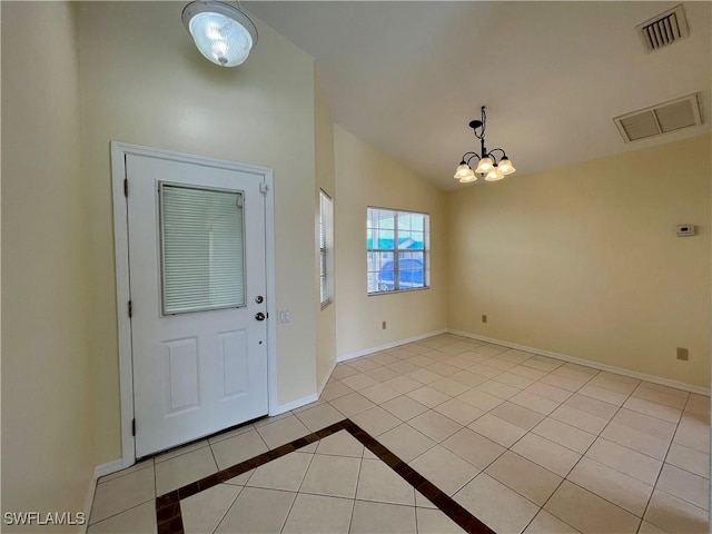 foyer with vaulted ceiling, tile patterned floors, baseboards, and a chandelier