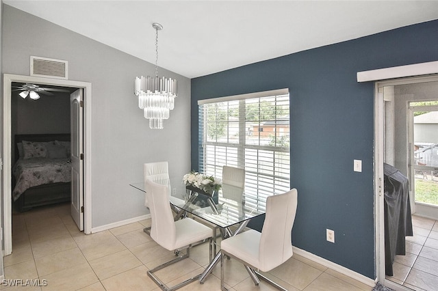 3408 26th St SW, Lehigh Acres, FL 33976 - dining room with lofted ceiling, a chandelier, baseboards, light tile patterned floors, and ceiling fan