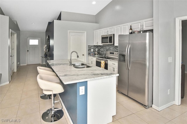 3408 26th St SW, Lehigh Acres, FL 33976 - kitchen with stainless steel appliances, a sink, and light tile patterned floors