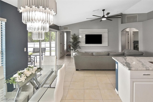 3408 26th St SW, Lehigh Acres, FL 33976 - living area with a ceiling fan, lofted ceiling, arched walkways, a chandelier, and light tile patterned floors