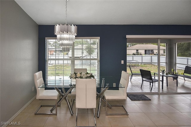 3408 26th St SW, Lehigh Acres, FL 33976 - tiled dining room featuring a chandelier, plenty of natural light, and baseboards