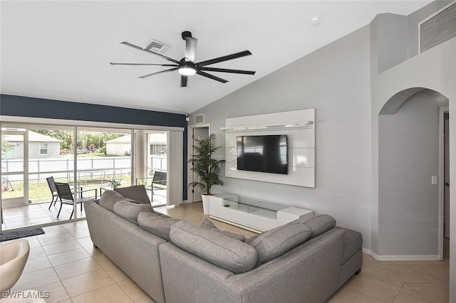 3408 26th St SW, Lehigh Acres, FL 33976 - living room with light tile patterned floors, arched walkways, a ceiling fan, high vaulted ceiling, and baseboards