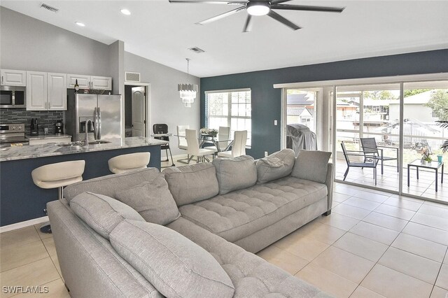 3408 26th St SW, Lehigh Acres, FL 33976 - living area featuring lofted ceiling, ceiling fan, light tile patterned floors, recessed lighting, and a chandelier