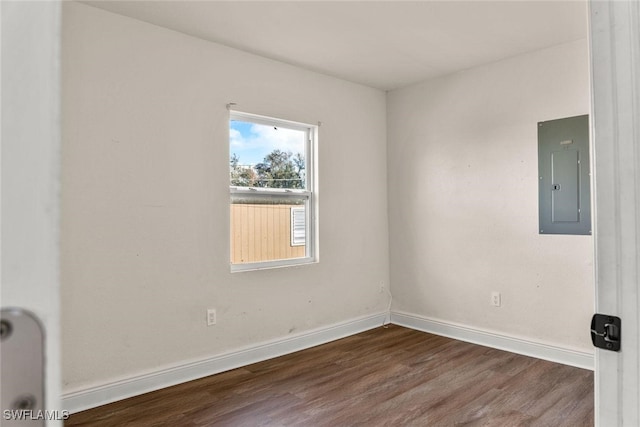 25/27 Cypress St, North Fort Myers, FL 33903 - empty room featuring electric panel, dark wood-style floors, and baseboards