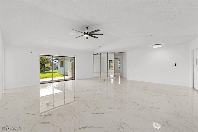 1306 SW 10th Pl, Cape Coral, FL 33991 - empty room featuring marble tiled floors, a textured ceiling, a ceiling fan, and vaulted ceiling