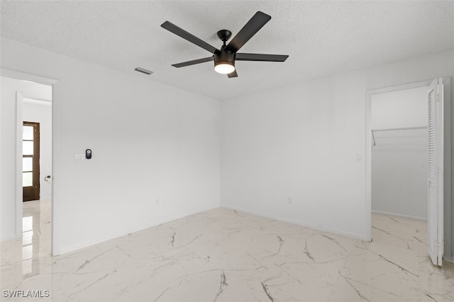 1306 SW 10th Pl, Cape Coral, FL 33991 - unfurnished room featuring ceiling fan, light marble finish floors, a textured ceiling, and baseboards