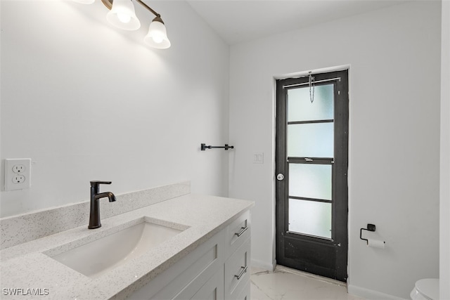 1306 SW 10th Pl, Cape Coral, FL 33991 - bathroom featuring marble look tile flooring, baseboards, vanity, and toilet