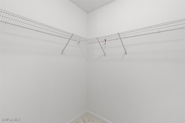 1306 SW 10th Pl, Cape Coral, FL 33991 - walk in closet featuring marble finish flooring
