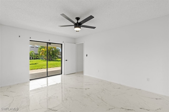 1306 SW 10th Pl, Cape Coral, FL 33991 - spare room with marble tiled floors, a textured ceiling, ceiling fan, and baseboards