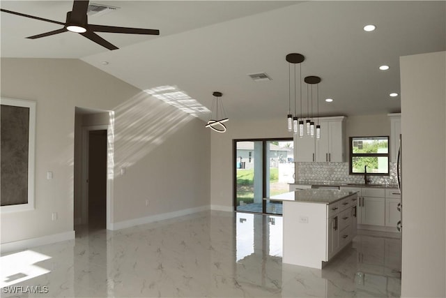 1013 Agnes Ave, Lehigh Acres, FL 33971 - kitchen featuring a center island, recessed lighting, white cabinetry, open floor plan, and decorative backsplash
